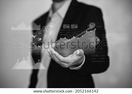 Businessman interaction with artificial intelligence to invest bitcoin price digital chart exchange. Concept of cryptocurrency and nft of blockchain technology on stock market. Black and white tone.