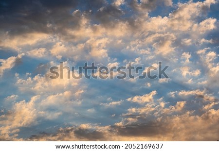 Blue sky with clouds at sunrise. Morning sky background