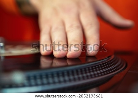 Hip hop dj scratching vinyl record on turntable. Professional disc jockey scratches records on retro turntables. Curated collection of royalty free music images and photos for poster design template