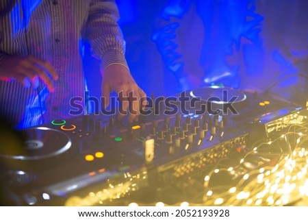 DJ console, music party, music creation process, nightclub, garlands of lights, electronic music, dubstep