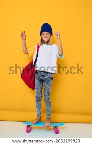 schoolgirl with a skateboard on his head yellow background