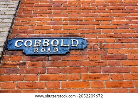 A vintage cast iron street sign, one of the older types of sign in the UK labeling Cobbold Road in Felixstowe town center