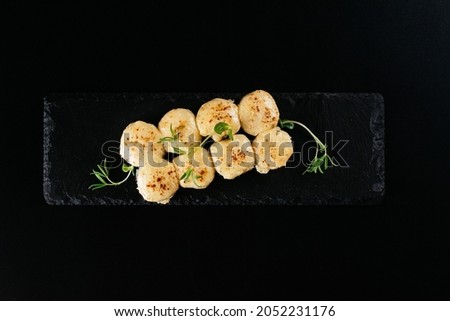 Sushi and soy sauce in a bowl and wooden chopsticks on a gray wooden table. Japanese food. Sushi Set. Variety of rolls. Menu.