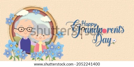 Happy Grandparent's Day greeting banner. Cartoon grandparents with lettering and forget-me-not flowers on die cut layered background. Senior couple flat design. Cute old man hugging old lady. Royalty-Free Stock Photo #2052241400