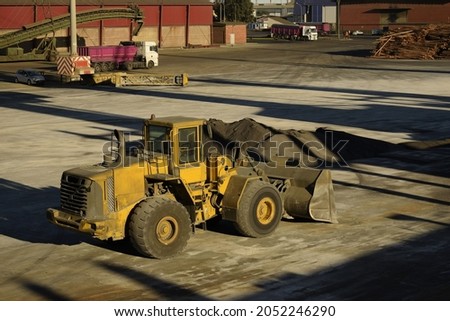 a bulldozer or payloader preparing fertilizer cargo in a heap  Royalty-Free Stock Photo #2052246290