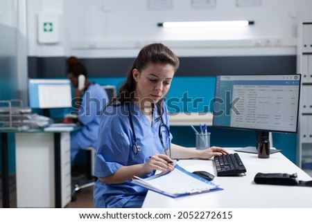 Pharmacist nurse with stethoscope analyzing healthcare treatment on medical documents typing sickness expertise working in hospital examination office. Woman asisstance checking disease results