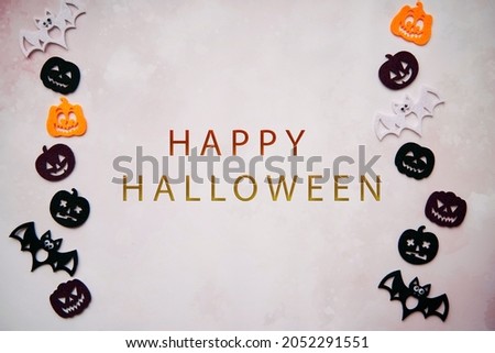 Happy Halloween lettering with Halloween decorations with bats, cute pumpkins. Minimalistic festive concept. High quality photo.