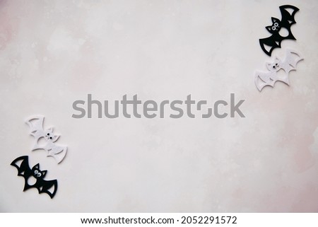 Minimalistic concept of Halloween black and white bats decorations. Top view. Minimalist holiday concept. Copy space for text. Happy Halloween, trick or treat concept. High quality photo