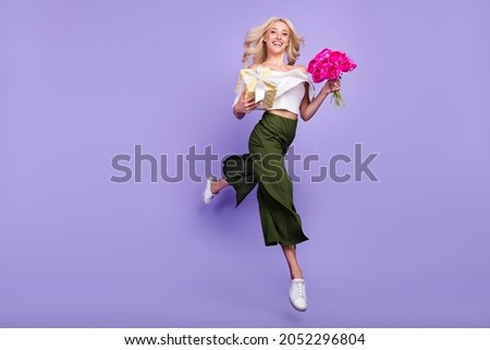 Full length body size girl jumping up keeping present flowers bouquet isolated pastel purple color background