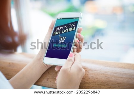 BNPL Buy now pay later online shopping concept.Hands holding mobile phone Royalty-Free Stock Photo #2052296849