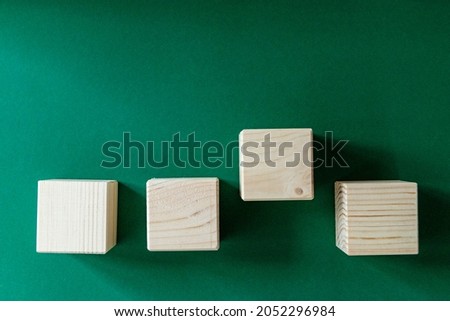 wooden cubes against emerald green background