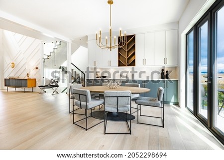 contemporary living room with open concept view through to dining room kitchen and a marble fireplace with gas fire Royalty-Free Stock Photo #2052298694