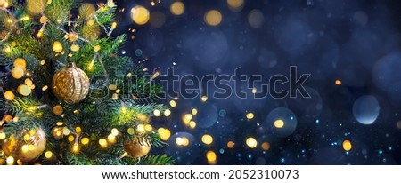 Christmas Tree In Blue Night - Golden Balls On Fir Branches With Defocused Lights In Abstract Background