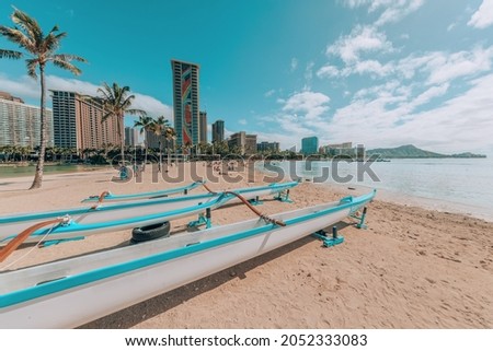 Waikiki beach landscape with racing canoe boats. Honolulu city, Oahu, Hawaii, USA famous summer travel destination.