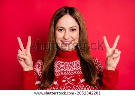 Portrait of attractive cheerful girl showing double v-sign good mood festal day isolated over vibrant red color background