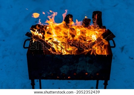 Brazier with fire and coals for cooking on the fire. Background