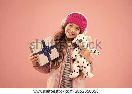 Cute dog toy quickly became her favourite friend. Happy child got toy gift pink background. Little girl cuddle soft toy and gift box. Birthday gift or present. Just the toy to let imaginations play Royalty-Free Stock Photo #2052360866