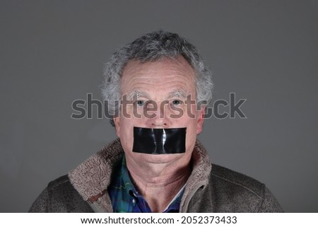 An ordinary citizen - the everyman -gagged by government or big business or some unfathomable reason Royalty-Free Stock Photo #2052373433