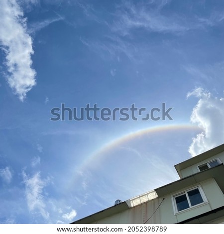 It's a picture of a rainbow floating in the clear sky.