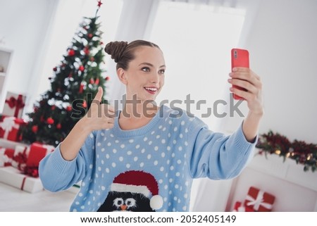 Portrait of attractive cheerful girl blogging making selfie showing thumbup winter day eve tradition at home indoors