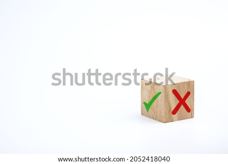 Checklists and quizzes. cross and a check mark on wooden cube. concept of denial wrong answer and correct answer, right decision. with copy space for business designs