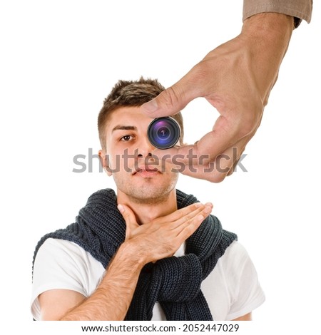 Young guy having health asphyxiation problem, male hand holding mini spy camera in the foreground