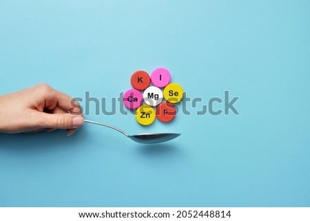 Icons of minerals and macronutrients on a spoon. The choice of food with a high content of vitamins and trace elements Royalty-Free Stock Photo #2052448814