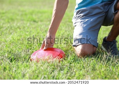 Young man playing frisbee in park, closeup