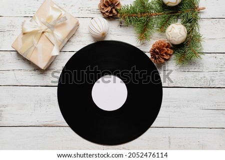 Vinyl disk and Christmas decor on wooden background