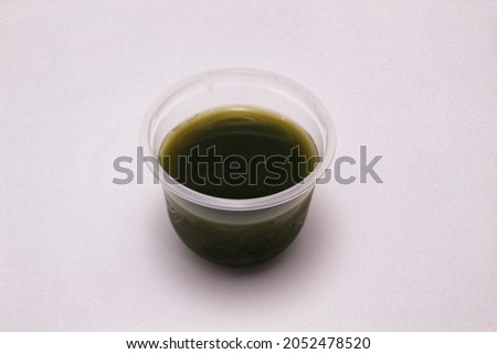 Product picture of grass jelly or cincau in a plastic cup or gelas plastik taken from a side view angle or top view angle 