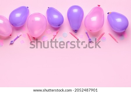 Balloons, candles and confetti on color background