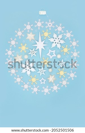 Christmas tree round shape bauble with star and snowflake decorations. Abstract composition for the holiday season on blue background. Flat lay, top view.