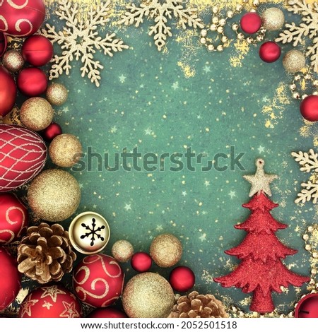 Festive background with Christmas tree, red and gold bauble decorations. Abstract Xmas composition for the holiday season. Top view, flat lay.
