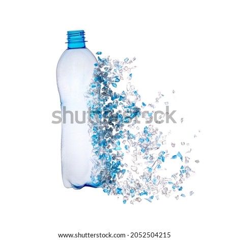 Top view of blue plastic bottle with PET bottle  transparent flakes around in white background. Plastic pollution recycle and World Environment Day concept. Royalty-Free Stock Photo #2052504215
