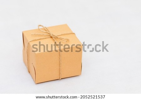 Holiday card. Beige gift box on white background. Flat lay,copy space.