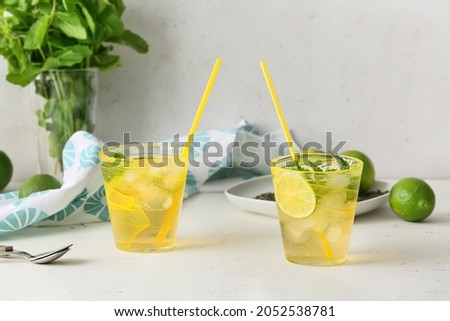 Cups of tasty cold ice tea on table