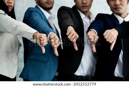 Group of five people business team show dislike or unlike thump down and unsuccessful job. Hands thumps down with disappoint vote in team concept. Business bankruptcy due to heavy coronavirus outbreak Royalty-Free Stock Photo #2052552779