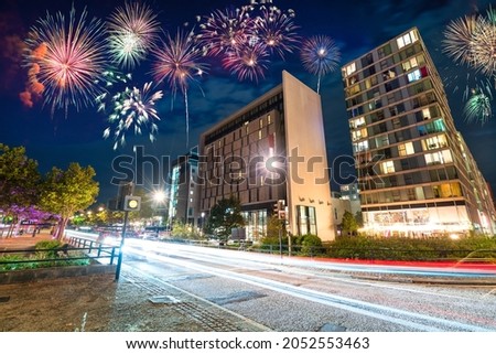 Fireworks display at Milton Keynes city centre at dusk. England Royalty-Free Stock Photo #2052553463