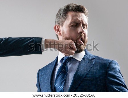 Hes a punching bag. Employee got punch in chin. Man punched in face. Fighting and punching Royalty-Free Stock Photo #2052560168