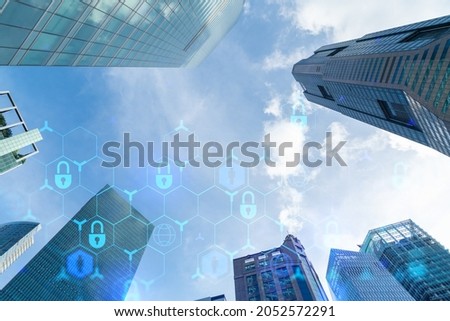 Hologram padlock icons symbolize the business protection in Asia over low angle shot of Singapore skyscrapers. The concept of information security shields. Double exposure.