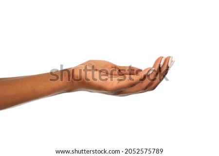 Mature african woman hand isolated against white background. Close up of black open palm hand. Isolated empty female hand showing your product or something.  Royalty-Free Stock Photo #2052575789