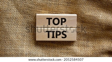 Top tips symbol. Concept words Top tips on wooden blocks on a beautiful canvas background. Business and Top tips concept, copy space.