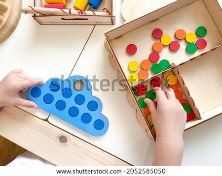 Montessori material. Wooden toys. Children's hands. Educational logic toys for children. Games for child development.Education in kindergarten and nursery. Preparation for school.