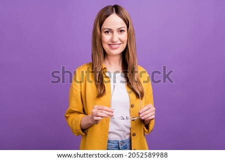 Photo of attractive aged woman good mood hold eyeglasses clever isolated over violet color background