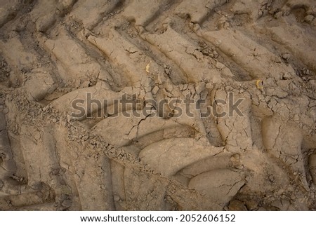 Wheel trail on sandy ground from large transport, tractor on construction site, sandy road