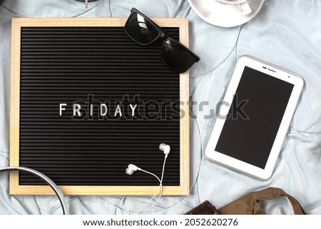 Friday flat lay concept with multimedia accessories, books and pens, glasses, alarm clock, flowers and coffee for refreshment on white background