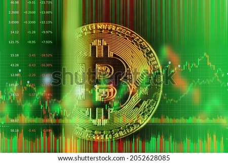 Bitcoin golden coin on abstract green financial market stock charts trading screen monitor background.	
