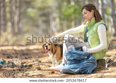 A woman removes rubbish in nature. High quality photo