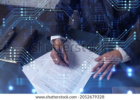 African American businesswoman is signing a contract to create a new software to present it in start up conference and gain investments to create a product. Technological graph over the desk.