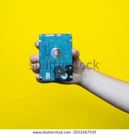 A 2.5-inch hard drive in a woman's hand